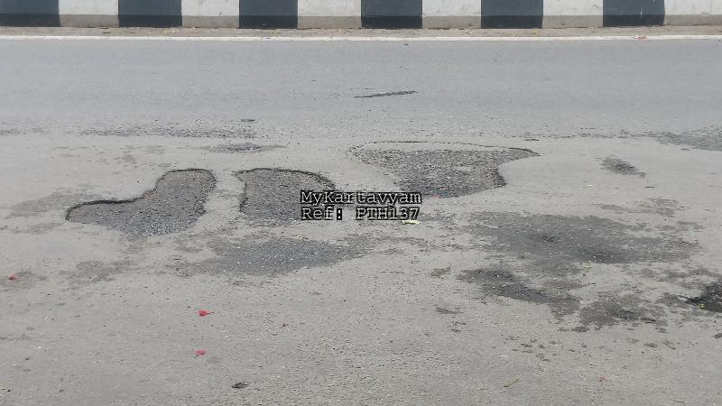 multiple Potholes in the middle of the road